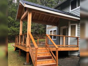 deck with roof, railings and staircase